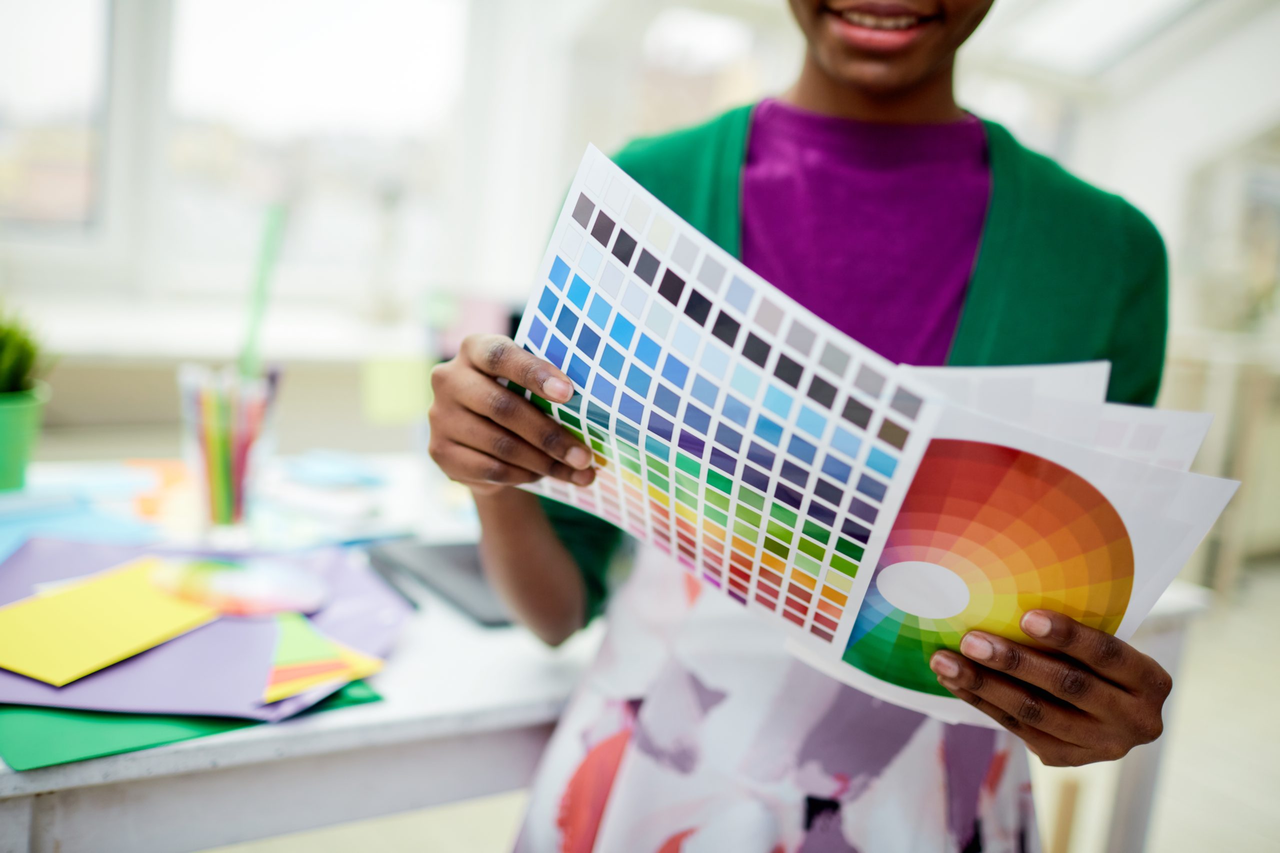 Swatch and diagram color palettes in hands of female